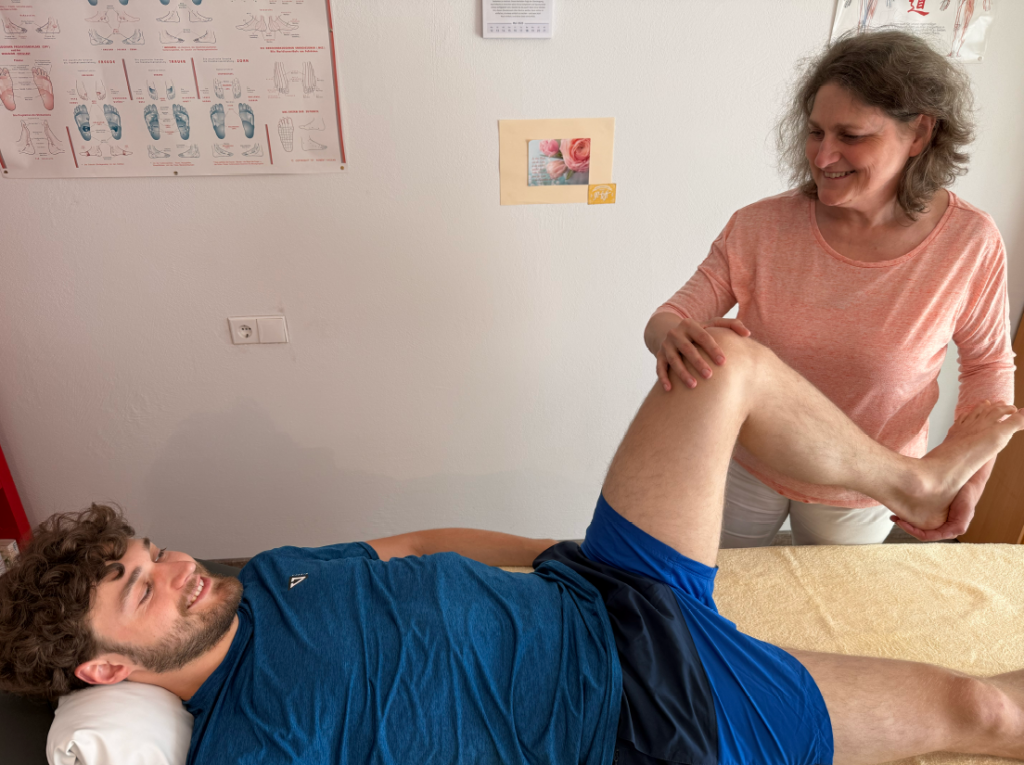 Krankengymnastik/Physiotherapie in Göppingen, Patient liegt auf Tisch und wird von Physiotherapeutin und Krankengymnastik-Expertin Dietlinde Liptak behandelt.